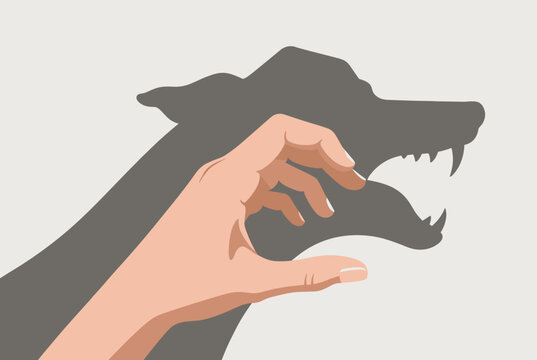 Creative hand shadow puppet of a growling wolf with sharp teeth showing shadow play fun on a beige wall.