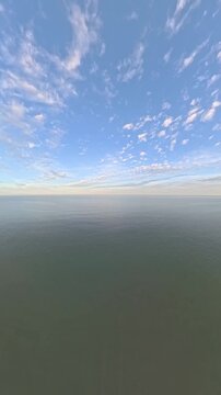 Vertical HD Aerial Drone Footage of Calm Open Ocean at Dusk for Mobile