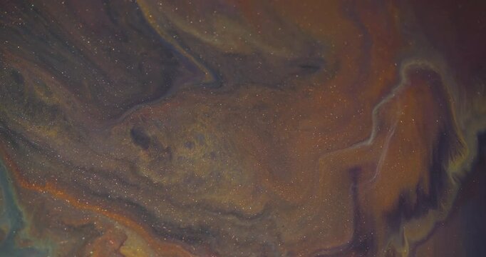 Ink splatter. Color glitter mix. Defocused orange yellow blue bright water ripple marble flow spill on abstract acrylic art background.