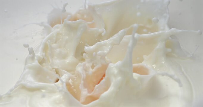 Peach slices falling into milk with splash in super slow motion 1000 fps