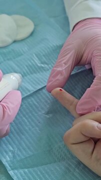 Medical professional performs blood test on patient in clinical setting using a device and collection tubes