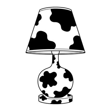 A charming table lamp with a classic rounded base and a conical lampshade, both adorned with a playful black and white cow print pattern, adding a touch of whimsical decor to any room