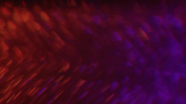 Defocused twinkle particles. Blur gleam. Duplicated lens flare prism stroboscopic bokeh rotation. Shiny color light leak orange violet abstract background.