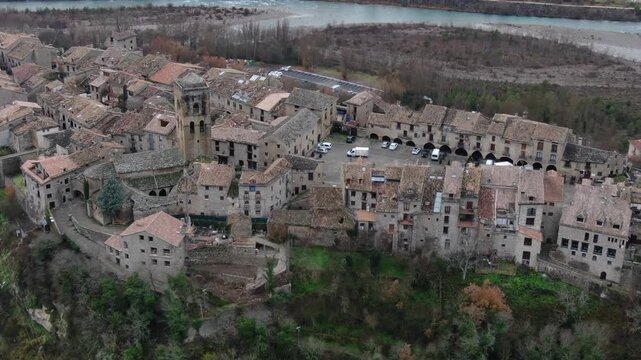 Picturesque aerial view of the historic medieval town of Ainsa. Charming village in the Pyrenees of Huesca, Aragon, featuring ancient stone buildings