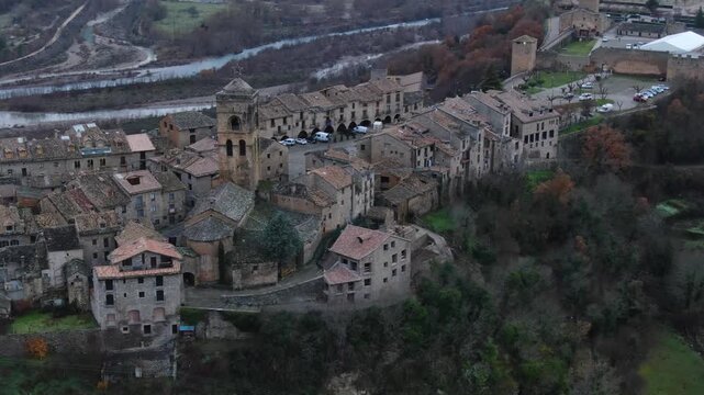 Aerial perspective of the ancient medieval town of Ainsa. Historic stone houses and narrow streets on a hill overlooking the river in Aragon, Spain