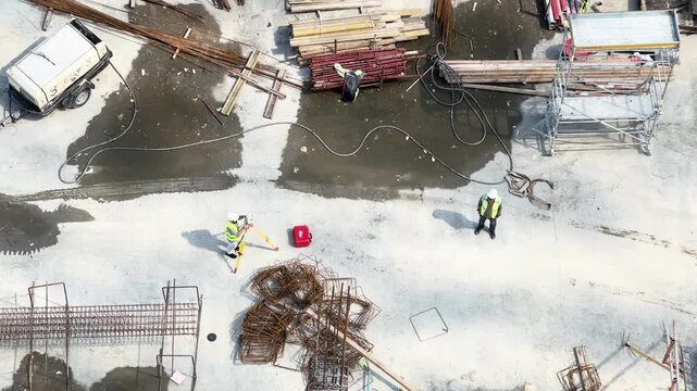 Builders Making Construction Measurements at Building Site Top View (16:9)