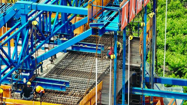 Workers Installing Steel Reinforcement on Bridge Deck at Construction Site
