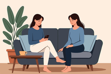 Obraz premium Two young female friends relaxing on a cozy blue sofa in a modern living room while checking a smartphone together.