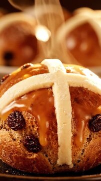 Cinematic View Of Glossy Glazed Hot Cross Bun In Closeup With White Cross Detail Raisins Inside And Steam Rising Ready To Serve