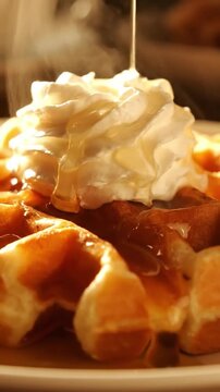 Cinematic View Of Belgian Waffle Grid Pattern With Maple Syrup Pooling In Holes Whipped Cream Dollop And Crispy Edges In Golden Morning Light Sharp Detail Food Commercial