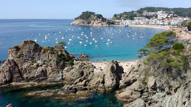 Aerial view of the rugged cliffs surrounding Tossa de Mar, where rocky reefs, hidden coves and crystal-clear Mediterranean waters create a spectacular coastal landscape. 