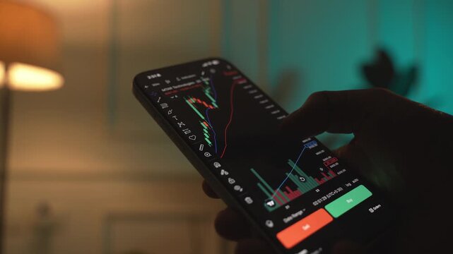 Trader Analyzing Stock Market Charts on Smartphone Through Brokerage App