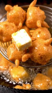 Macro Shot Of Paneer Cheese Cube Dipping In Gram Flour Batter Frying To Golden Crust With Soft Cheese Inside In Warm Indian Snack Lighting Traditional South Asian Food