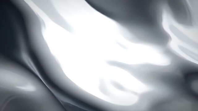 Abstract flowing metallic silver surface with soft lighting and highlights.