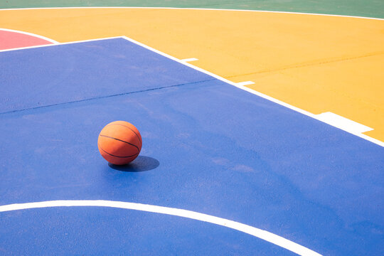 Basketball on outdoor sport court with colorful pattern on concrete floor surface, Sports field in minimal background design