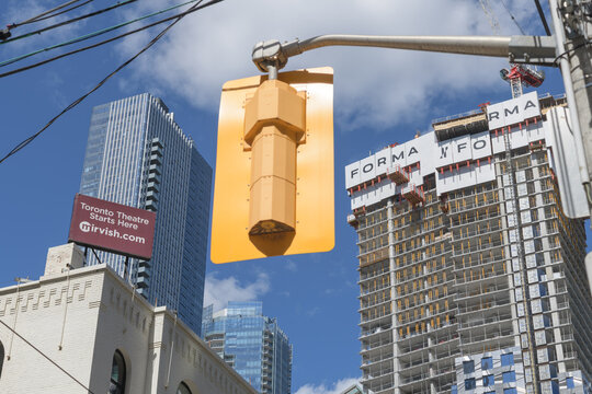 traffic light and Thomson Reuters Building (left) and FORMA Mirvish + Gehry condo under construction, Toronto