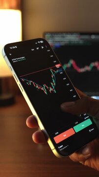 Trader Analyzing Stock Market Charts on Smartphone Through Brokerage App