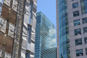 Fototapeta premium detail of FORMA (Mirvish + Gehry) condominium complex with articulated metallic surface, RBC Centre, and Metro Hall, King St W, Toronto