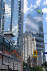 Fototapeta premium historic St Andrew's Presbyterian church set in context of Symphony Place condos, TD Terrace, and other office towers (looking south on Simcoe St, north of King W), Toronto