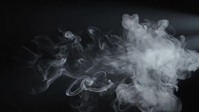 Wisps of smoke curl and drift in darkness, illuminated by subtle lighting.