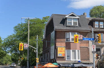Naklejka premium exterior building facade and sign of 3 Jit Variety, a convenience store, located at 1452 Bloor St W, Toronto