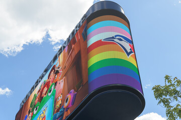 Naklejka premium Toronto Rogers Centre Gardiner LED Pylon (located at Rees St & Bremner Blvd) with advertisement for Toy Story 5 and Pride Month celebration with Toronto Blue Jays