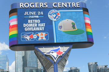 Fototapeta premium Toronto Rogers Centre Gardiner LED Pylon (located at Rees St & Bremner Blvd) with advertisement for Toronto Blue Jays retro Domer hat giveaway