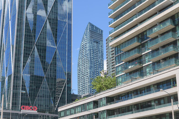 Fototapeta premium architectural tensions: CIBC Square (with diamond faceted curtain wall system), L-Tower with slope, and condo, Bay St, Toronto