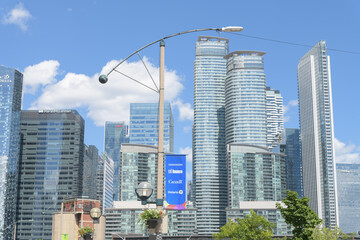 Fototapeta premium looking east on Bremner Blvd to pole mounted banner with sponsor logos of FIFA World Cup host city, Toronto