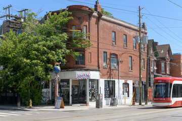 Naklejka premium exterior of historic apartment and commercial block at northeast corner of Augusta Av and Dundas W - location of Luke’s barber studio, Toronto