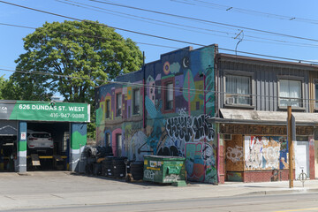 Fototapeta premium mural on side of old building and sign at 24/7 Auto Group (Kensington Automotive) 626 Dundas St W, Toronto
