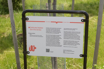 Fototapeta premium close-up of sign near Delicate Matter (for the birds), 2026, by Kara Hamilton at Lassonde Art Trail, Biidaasige Park, Toronto