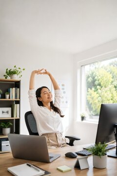 Woman stretching at desk with computer