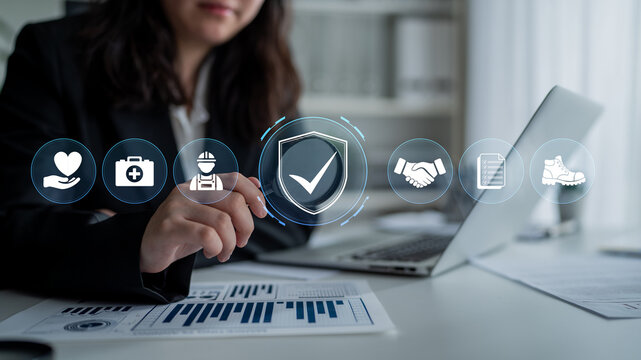 Business professional analyzing data with security icons, focusing on healthcare, construction, partnership, and safety in a modern office setting. Glyphic.