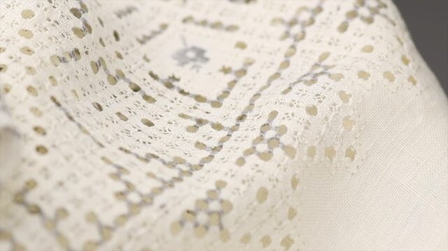 Cross stitch on linen fabric, handmade cross-stitch texture background, lace, natural eco folded linen tablecloth. Bio textile material backdrop, canvas top view, close up, rotating  