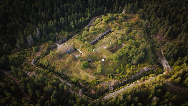 Aerial view of the historic Fort Guyot surrounded by dense coniferous forest and rugged terrain in Les Rousses, Bourgogne-Franche-Comte, France.