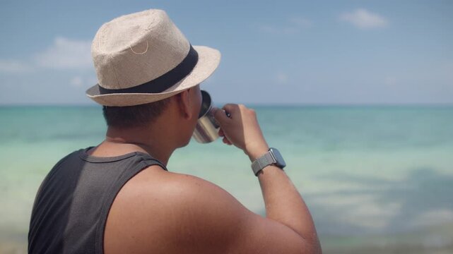 Man Sipping Coffee on a Tropical Beach in Sunny Weather, Showcasing Relaxation, Slow Living, Travel Freedom, and a Serene Vacation Atmosphere