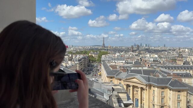 Woman Taking Pictures of Paris Cityscape