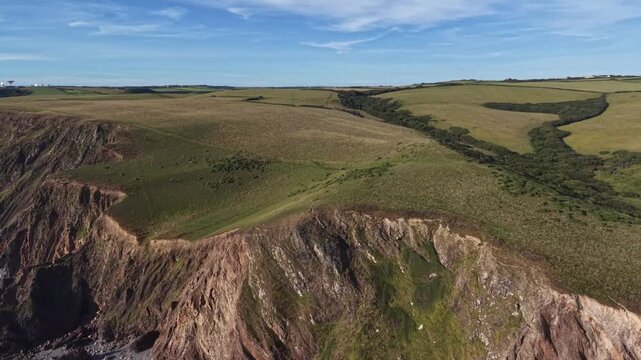 Green rugged landscape on the edge of the cliffs in Cornwall