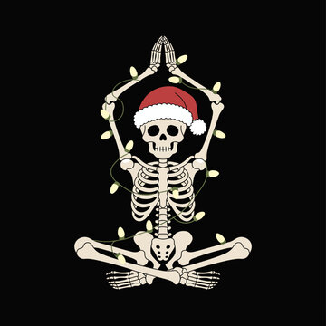 A skeleton is seated in a yoga pose, wearing a Santa hat and surrounded by glowing Christmas lights.