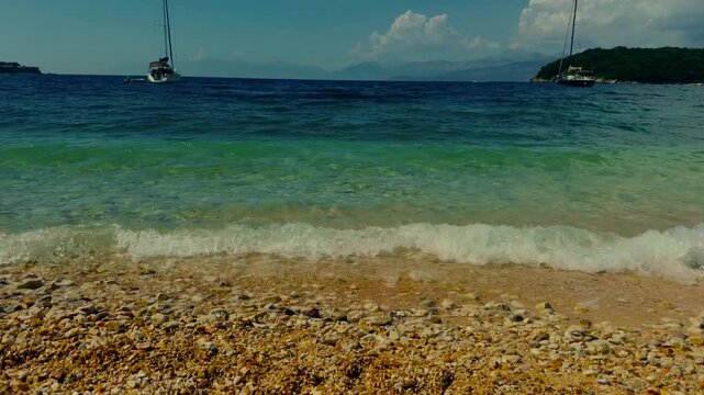 Turquoise Sea Waves Rolling On Pebble Beach With Yachts. Mediterranean Shoreline With Sailing Boats