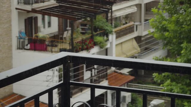 Raindrops Falling On Metal Balcony Railing.Rain In Residential Urban Area With Apartment Buildings. Rainy Summer Weather