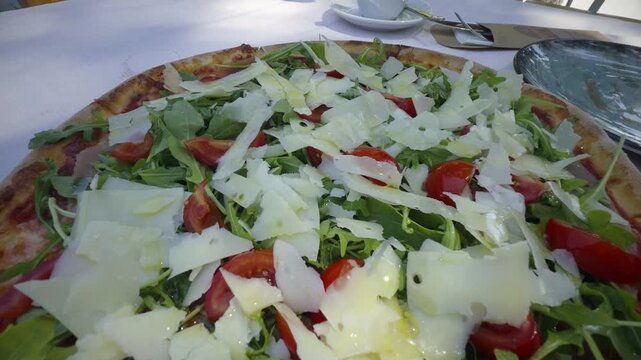 Fresh Italian Pizza With Prosciutto Ham Arugula Cherry Tomatoes And Parmesan Cheese Flakes. Mediterranean Culinary 