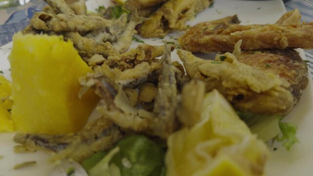 Fried Fish Dish Served With Lemon And Polenta. Mediterranean Seafood Platter. Crispy Anchovies And Sardines 