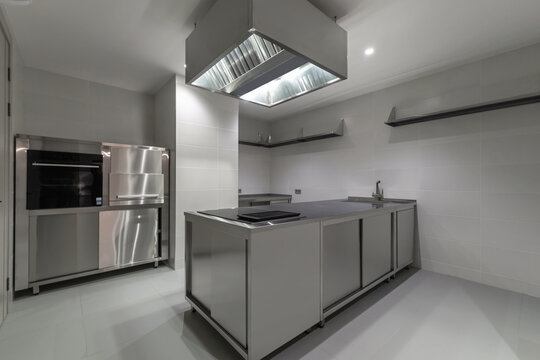 A spacious kitchen with stainless steel appliances and an open layout offers a functional space for cooking