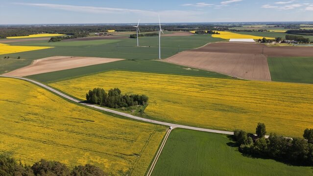 Aerial view of the straight road leading towards Bj&auml;rka-S&auml;by New Castle (Nya Slottet) in Sweden. Cinematic drone perspective of a rural road and historic European architecture.