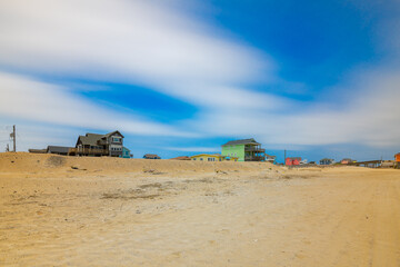 Fototapeta premium Beach homes on the verge of being washed away on the outer banks of North Carolina near Buxton and Rodanthe
