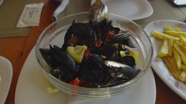 Steamed Mussels With Tomatoes And Herbs. Mixing Fresh Seafood Dish. Mediterranean Cuisine