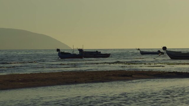 Wooden Fishing Boats Near Sandy Shore At Sunset. Coastal Marine Landscape