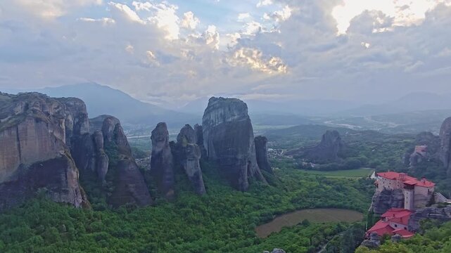 Aerial view of Meteora monasteries and the rock formations in the mountains of Greece near Kalabaka city. Monastery of the Holy Trinity. Unesco world heritage site. Drone Video